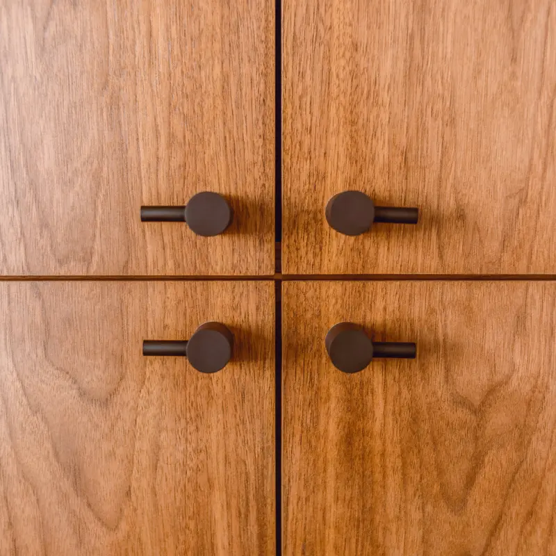 A close-up of a veneered cabinet. Fixation Surface Repair Specialists offer expert repair & restoration.